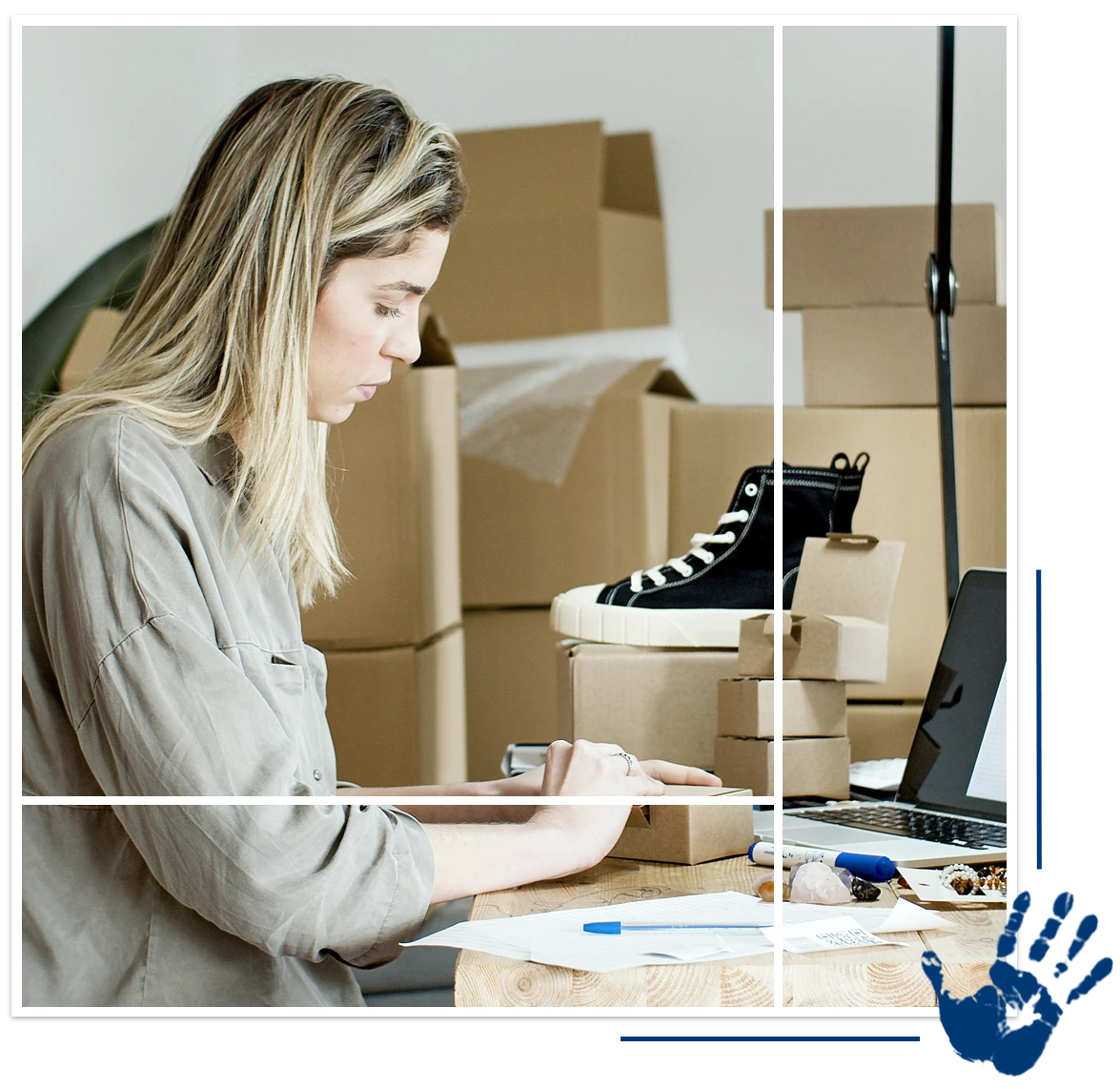 A woman sitting at her desk in front of boxes.